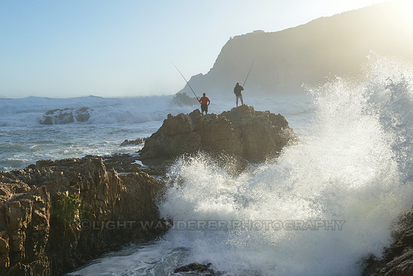 Men fishing standing on the rock
