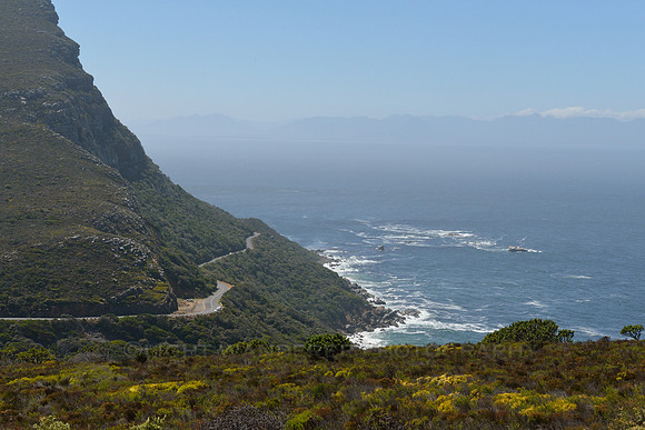 Coastal road beneath high cliffs