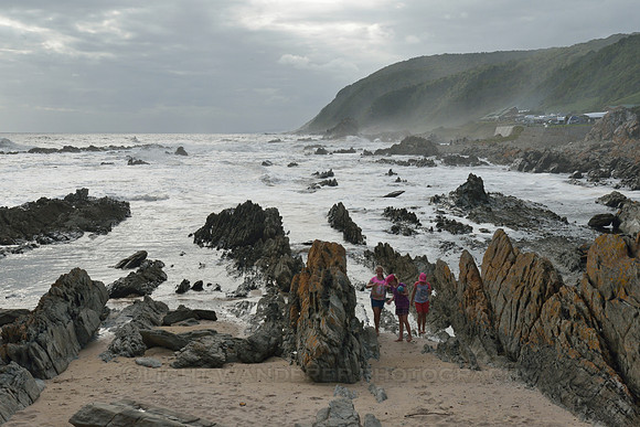 Children between the rocks on the beach
