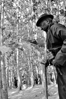 Old man with walking stick and prayer mill