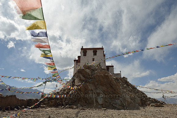 Stakna gompa with lines of prayer flags