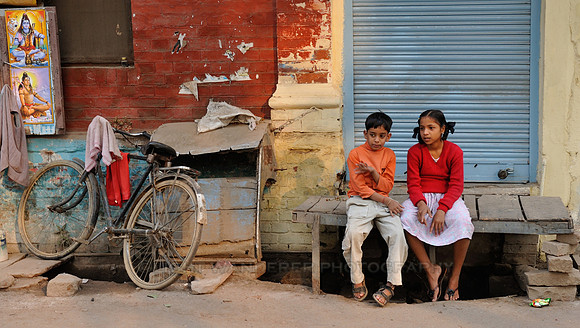 Brother and sister sitting together, looking at something