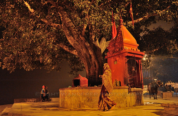 Woman circling holy tree and temple