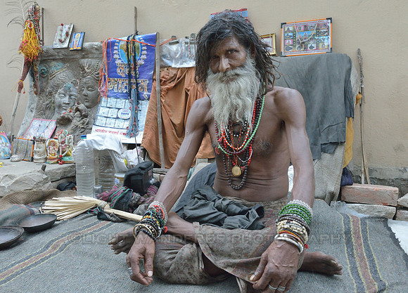 Sadhu in front of his picture collection