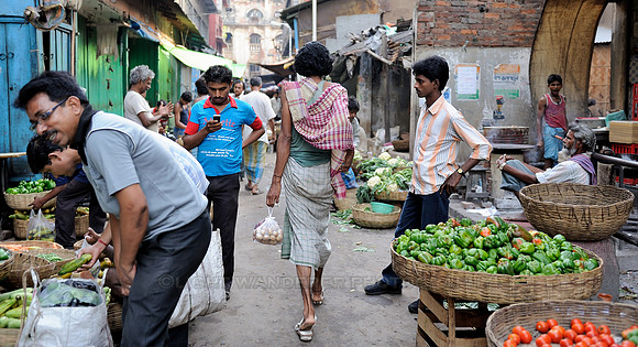 Man walking through vegetable market