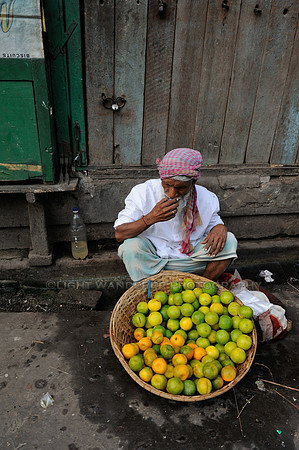 Street hawker with lime fruits