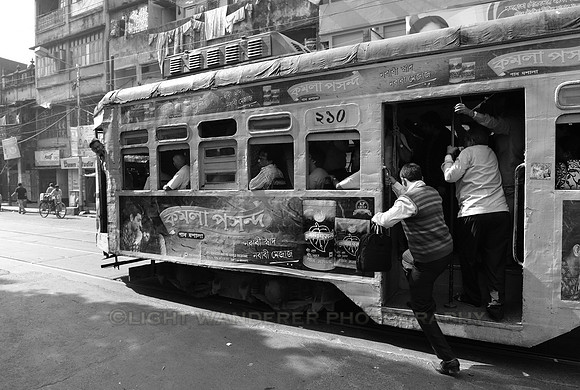 Man stepping in a moving tram
