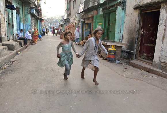Two children running hand in had