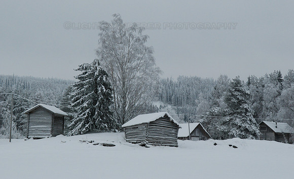 Old barns in snow covered field