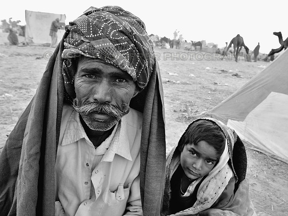 Man wearing a turban and large mouctache with a young boy