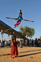 Young gypsy girl tightrope walking