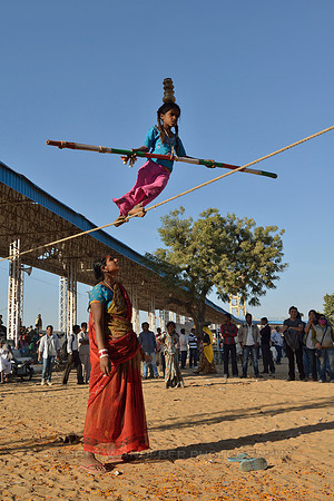 Young gypsy girl tightrope walking