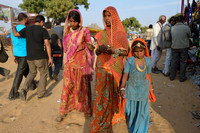 Two women and a girl in colourful clothes