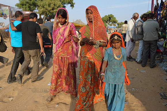 Two women and a girl in colourful clothes