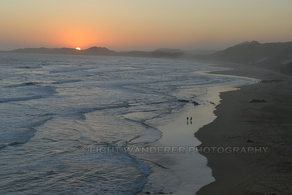 Couple walking on the beach sunset time