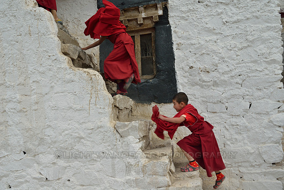 Young monks hurrying up the stairs