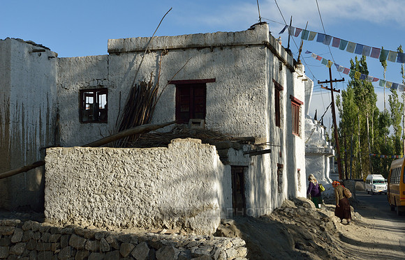 Women entering a village house