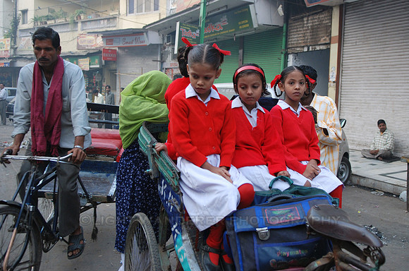 School girls sitting in bicycle rikshaw