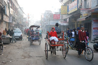 Kids going to school by bicycle rikshaw