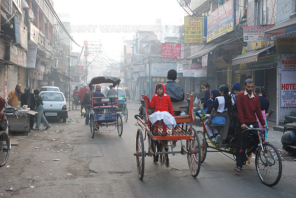 Kids going to school by bicycle rikshaw