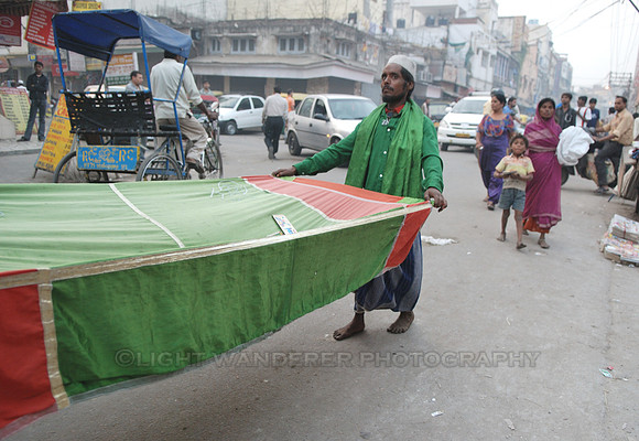 Muslim man collecting alms on a sheet