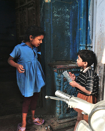 Kids in discussion by the front door of their home