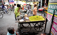 Young man selling sweet lime fruits