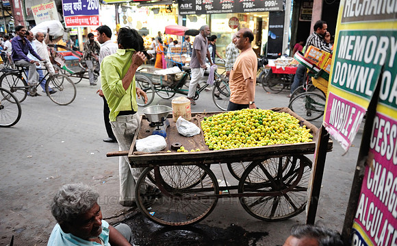 Young man selling sweet lime fruits