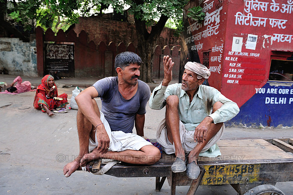 Men in discussion, sitting on a hand pulled cart