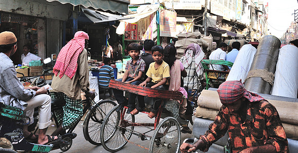 Brothers sitting at the back of a bicycle rikshaw
