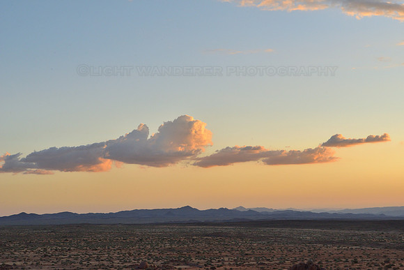 Clouds over desert at sunset