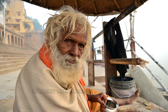 Old sadhu by Ganges river in the morning