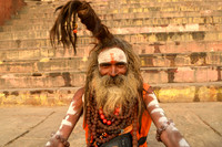 Smiling sadhu with dreadlocks pointing up