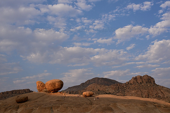 Huge boulders, people walking on the rocks